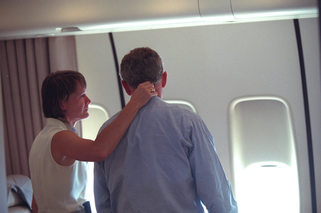 The president is consoled by presidential nurse Cindy Wright, of the White House Medical Unit, aboard Air Force One. | Eric Draper/George W. Bush Presidential Library and Museum